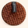 Round Brown Textured Cleaning Sponge — actual item with edited cream background